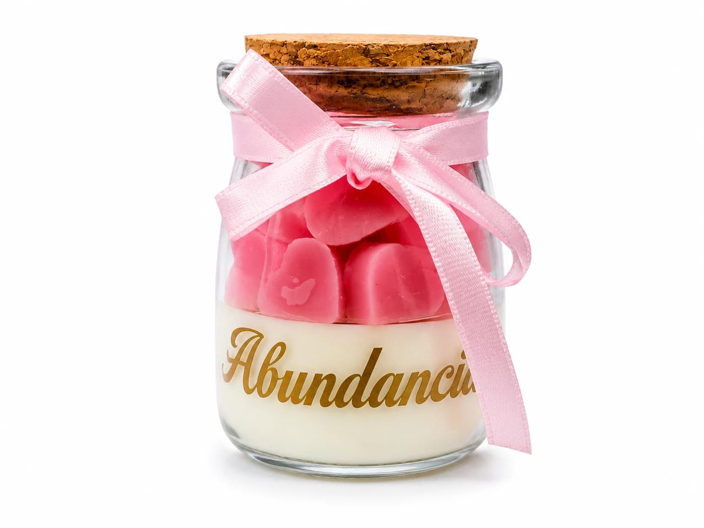 Vela aromática pequeña en frasco de vidrio con tapa de corcho, cera en corazones rosados y lazo